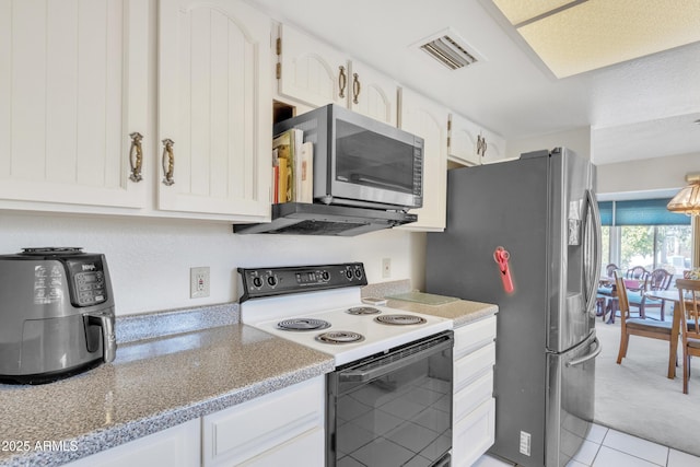 kitchen with stainless steel appliances and white cabinets