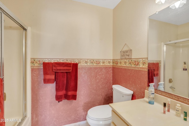 bathroom with vanity, tile walls, an enclosed shower, and toilet