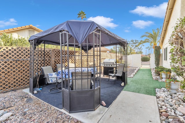 view of patio / terrace featuring a gazebo and a grill