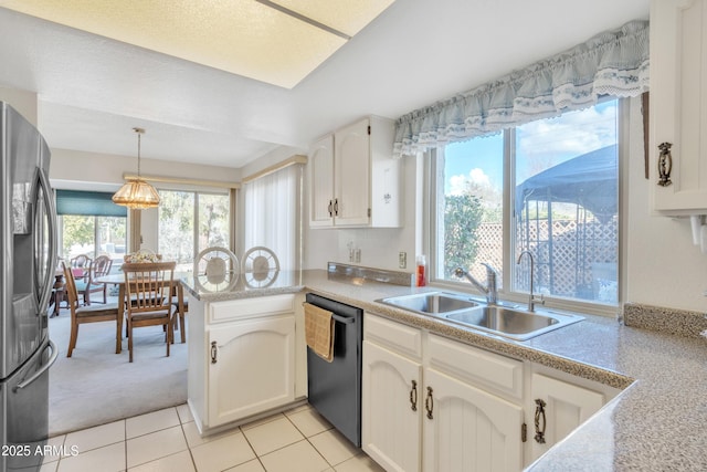 kitchen featuring pendant lighting, stainless steel fridge, white cabinetry, black dishwasher, and kitchen peninsula