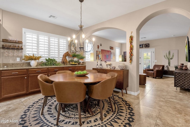 dining room featuring visible vents and a notable chandelier