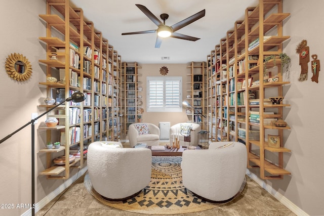 sitting room with ceiling fan, visible vents, and baseboards