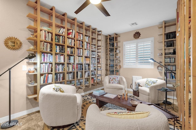 sitting room featuring visible vents, ceiling fan, and baseboards