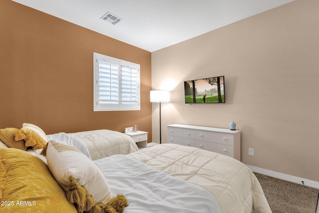 carpeted bedroom featuring baseboards and visible vents