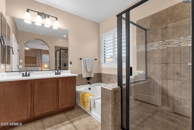 bathroom featuring a sink, a shower stall, a bath, tile patterned floors, and double vanity