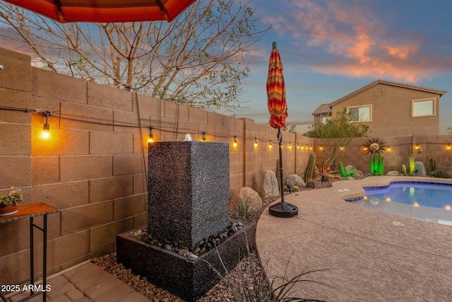 view of pool featuring a fenced backyard and a patio