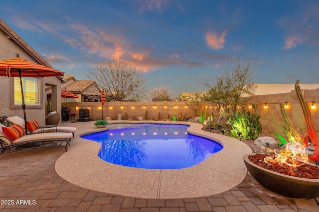 view of pool featuring a fenced backyard, a fenced in pool, and a patio