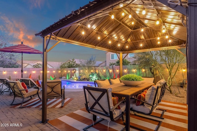 view of patio featuring outdoor dining space, a fenced backyard, a fenced in pool, and a gazebo