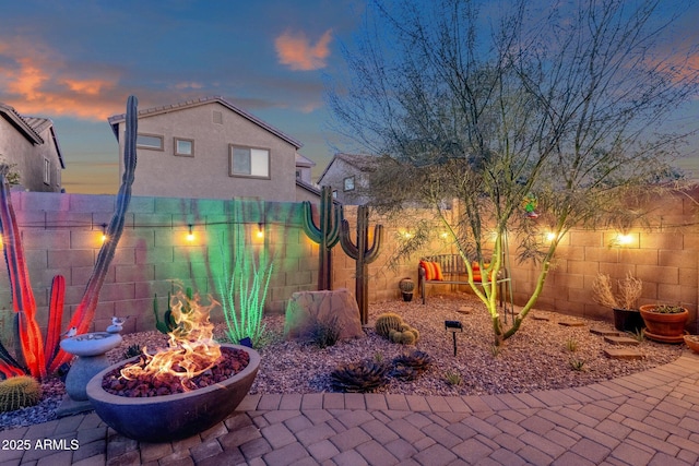 view of patio featuring a fenced backyard and a fire pit