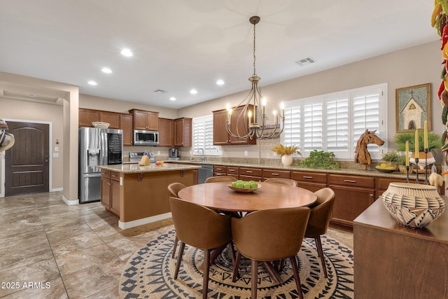 dining space featuring recessed lighting, visible vents, baseboards, and an inviting chandelier