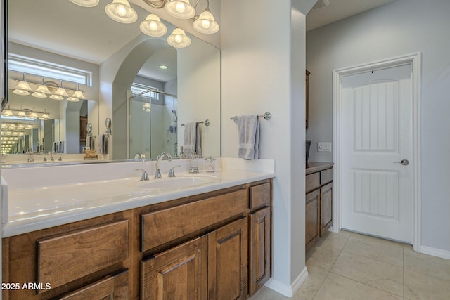 bathroom with a shower stall and vanity