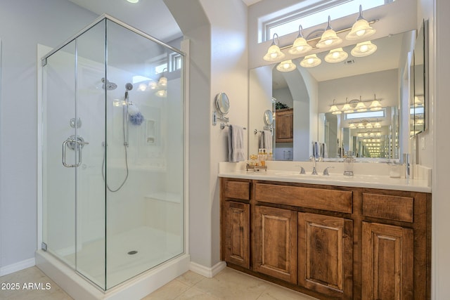 bathroom with a shower stall, tile patterned flooring, and vanity