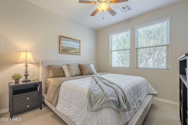 bedroom featuring baseboards, a ceiling fan, visible vents, and light colored carpet