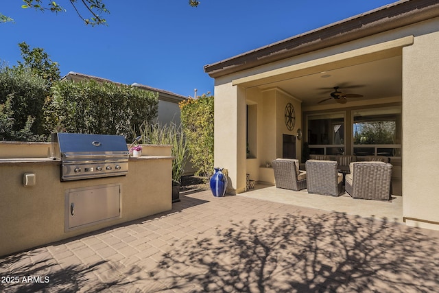 view of patio with a ceiling fan, exterior kitchen, and area for grilling