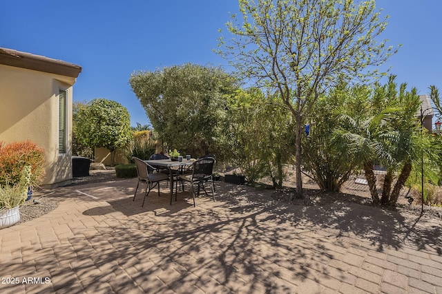 view of patio with outdoor dining area and fence