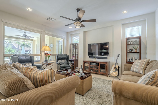 carpeted living area with a ceiling fan, recessed lighting, and visible vents