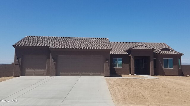 300 W Quartz Rock Rd, Phoenix, AZ 85085 - view of front facade with an attached garage, driveway, stucco siding, and a tiled roof