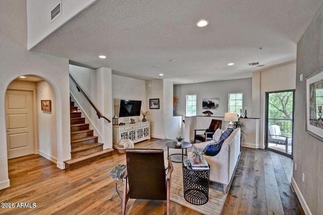 3935 E Rough Rider Rd Unit 1360, Phoenix, AZ 85050 - living area featuring hardwood / wood-style floors, stairway, baseboards, a textured ceiling, and recessed lighting