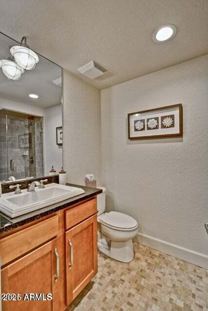 3935 E Rough Rider Rd Unit 1360, Phoenix, AZ 85050 - full bathroom featuring a shower stall, toilet, vanity, recessed lighting, and tile patterned floors