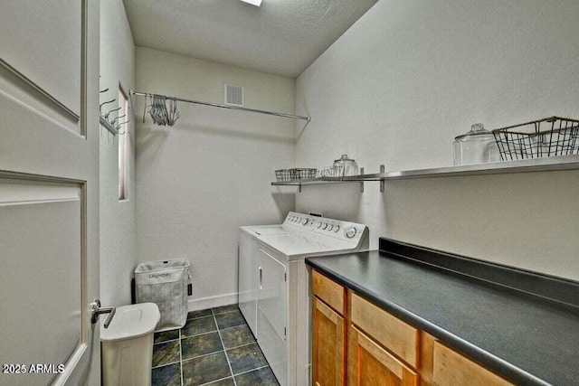 3935 E Rough Rider Rd Unit 1360, Phoenix, AZ 85050 - clothes washing area with washer and dryer, cabinet space, baseboards, a textured wall, and dark tile patterned flooring