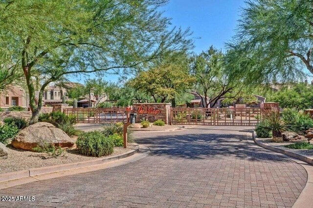 3935 E Rough Rider Rd Unit 1360, Phoenix, AZ 85050 - view of decorative road featuring curbs, a gate, and a gated entry