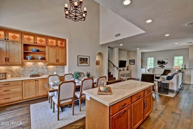 3935 E Rough Rider Rd Unit 1360, Phoenix, AZ 85050 - kitchen with arched walkways, dark wood-style flooring, open floor plan, light countertops, and recessed lighting