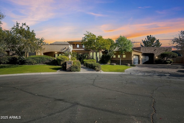 view of front of property with a lawn and a garage