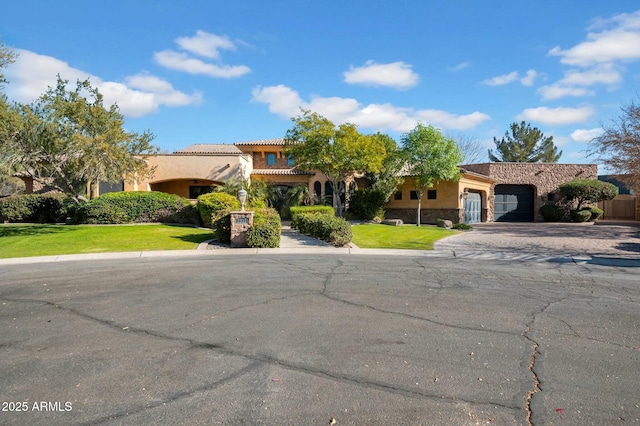 view of front of house featuring a garage and a front yard