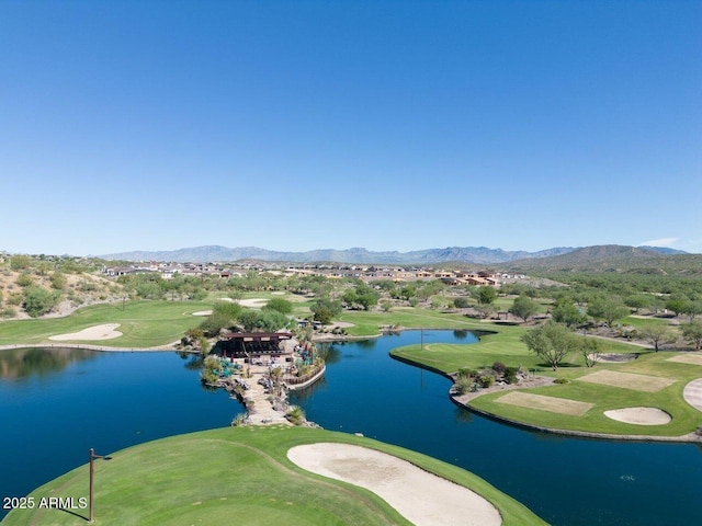 aerial view with golf course view and a water and mountain view