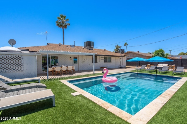 view of swimming pool featuring central AC, a patio, and a lawn