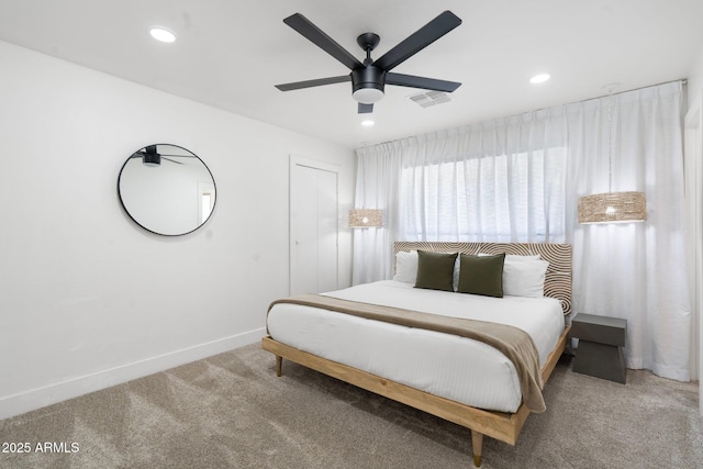 carpeted bedroom with a closet and ceiling fan