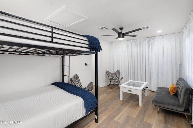 bedroom with wood-type flooring and ceiling fan