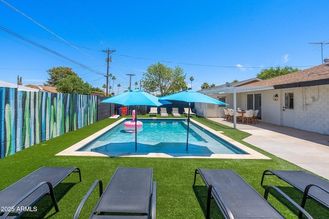 view of swimming pool with a yard and a patio area