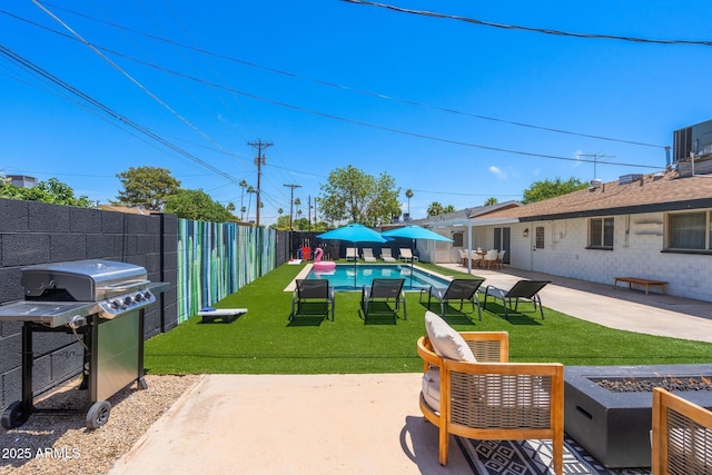 exterior space with a grill, a fenced in pool, and an outdoor fire pit