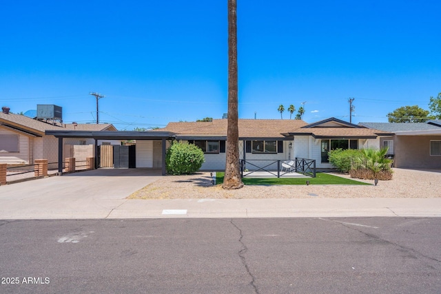 ranch-style house with cooling unit and a carport