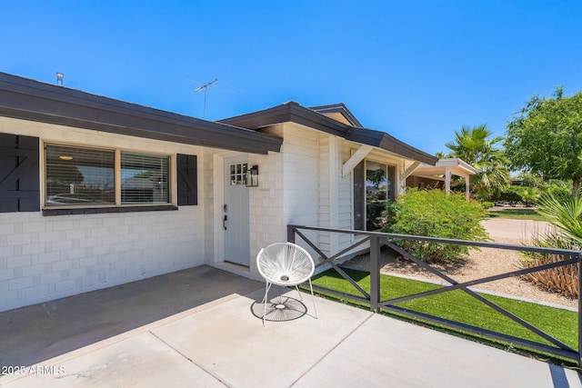 doorway to property featuring a patio area