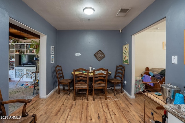 1712 E Montebello Ave, Phoenix, AZ 85016 - dining room featuring light wood finished floors and baseboards
