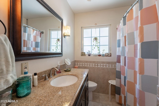 1712 E Montebello Ave, Phoenix, AZ 85016 - bathroom featuring tile walls, tile patterned floors, toilet, vanity, and a wainscoted wall