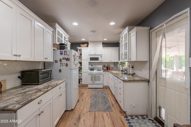 1712 E Montebello Ave, Phoenix, AZ 85016 - kitchen with white appliances, a sink, light wood-style floors, white cabinets, and recessed lighting