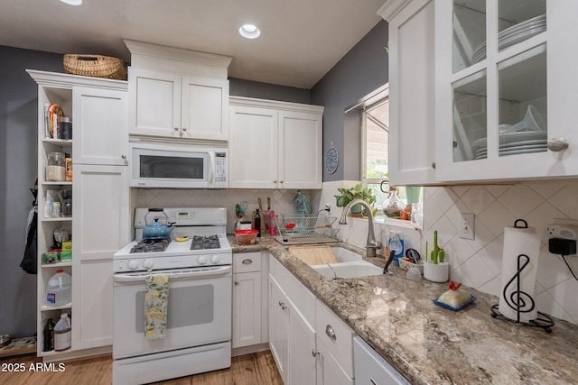 1712 E Montebello Ave, Phoenix, AZ 85016 - kitchen with white appliances, a sink, white cabinetry, light wood-style floors, and recessed lighting
