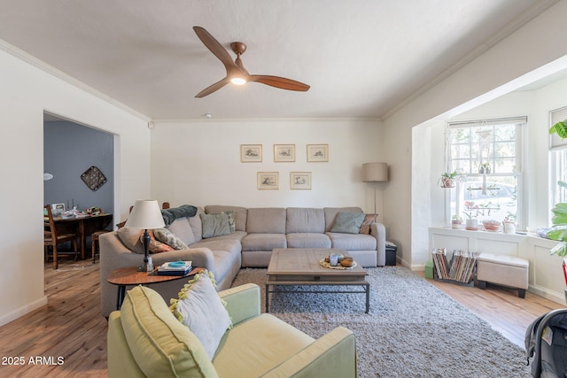 1712 E Montebello Ave, Phoenix, AZ 85016 - living area featuring ornamental molding, wood finished floors, a ceiling fan, and baseboards