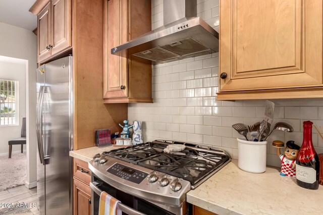4832 E Cambridge Ave, Phoenix, AZ 85008 - kitchen featuring stainless steel appliances, wall chimney exhaust hood, decorative backsplash, light stone counters, and brown cabinetry