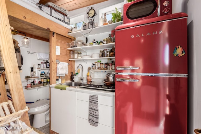 4832 E Cambridge Ave, Phoenix, AZ 85008 - kitchen featuring freestanding refrigerator, a sink, and white cabinetry