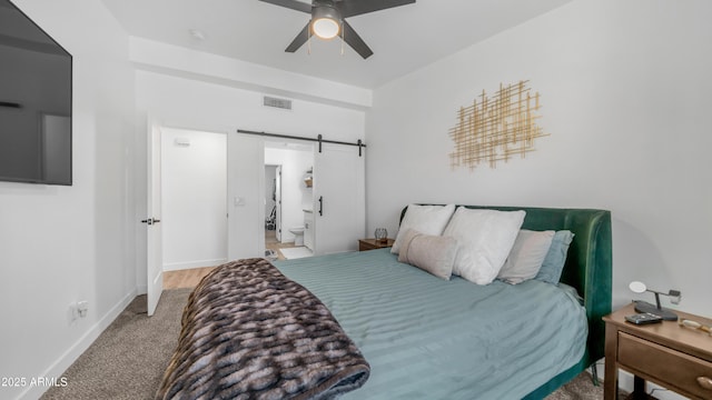 1717 W Roma Ave, Phoenix, AZ 85015 - bedroom featuring a barn door, carpet floors, baseboards, a ceiling fan, and connected bathroom