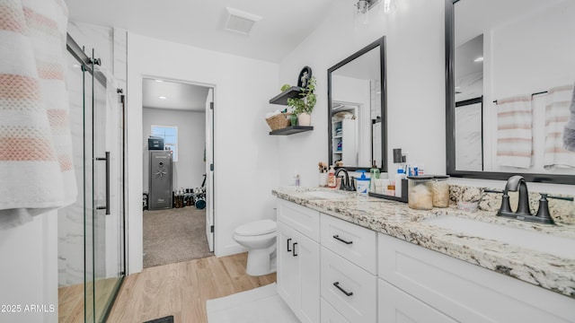 1717 W Roma Ave, Phoenix, AZ 85015 - full bathroom with wood finished floors, double vanity, a stall shower, and toilet