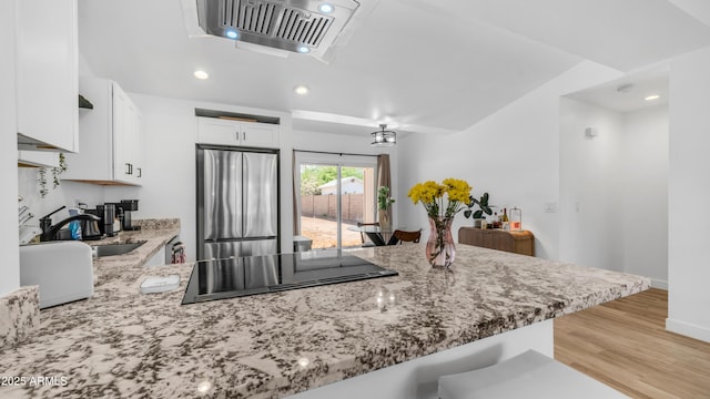 1717 W Roma Ave, Phoenix, AZ 85015 - kitchen featuring stainless steel fridge, black electric cooktop, light stone countertops, a peninsula, and recessed lighting