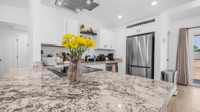 1717 W Roma Ave, Phoenix, AZ 85015 - kitchen with appliances with stainless steel finishes, white cabinetry, light stone counters, open shelves, and range hood