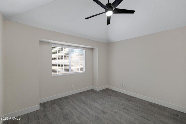 4165 E Huntington Dr, Phoenix, AZ 85040 - spare room featuring baseboards, dark wood-style floors, vaulted ceiling, and a ceiling fan