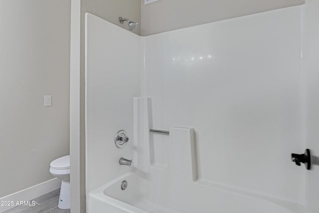 4165 E Huntington Dr, Phoenix, AZ 85040 - full bath with toilet, shower / tub combination, wood finished floors, and baseboards