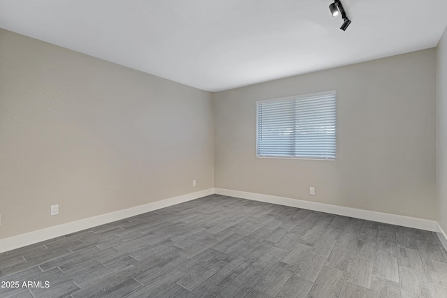 4165 E Huntington Dr, Phoenix, AZ 85040 - spare room featuring dark wood-style flooring and baseboards